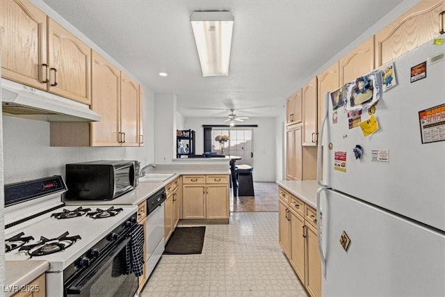 kitchen with ceiling fan, light brown cabinetry, white appliances, and sink