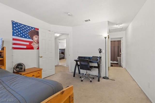 carpeted bedroom with ensuite bath