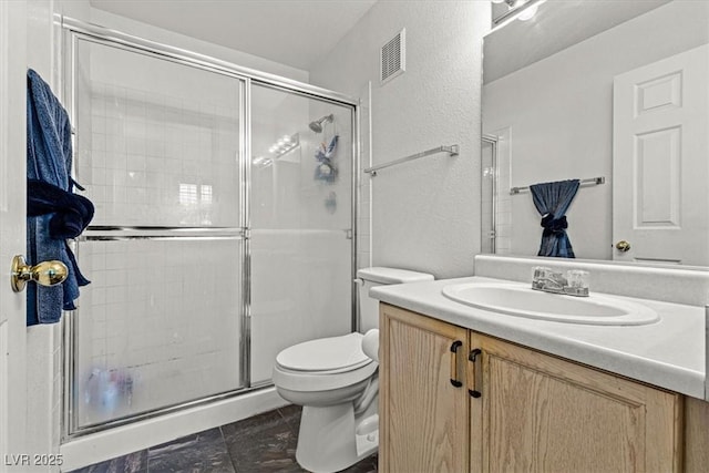 bathroom with vanity, toilet, and walk in shower