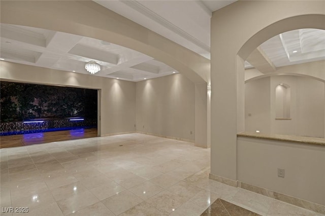 unfurnished living room featuring beam ceiling and coffered ceiling