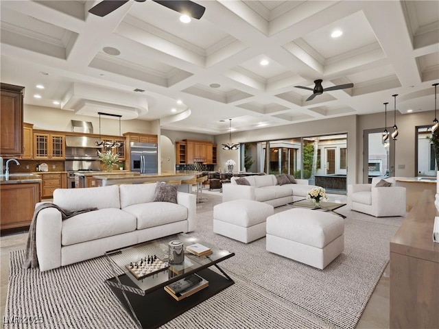 living room with ceiling fan, beam ceiling, sink, and coffered ceiling