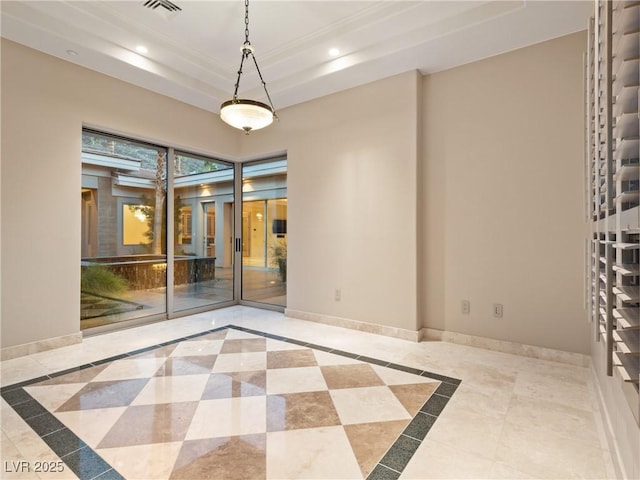 unfurnished room with a raised ceiling