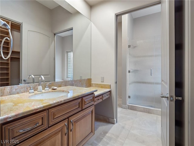 bathroom featuring tile patterned flooring, vanity, and walk in shower