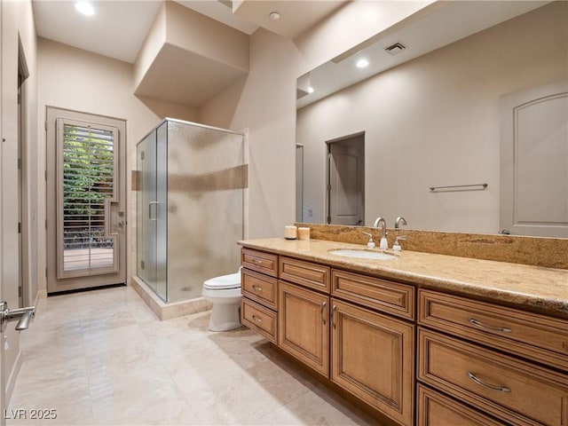 bathroom with walk in shower, vanity, and toilet