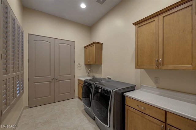 clothes washing area featuring cabinets, separate washer and dryer, and sink