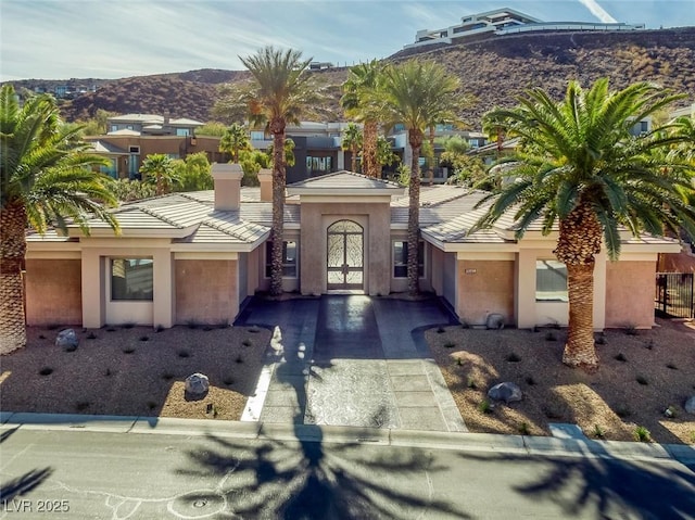 view of front of house with a mountain view and french doors