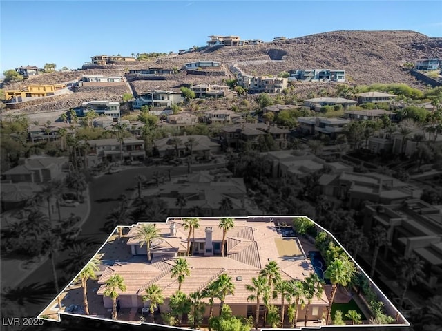 birds eye view of property with a mountain view