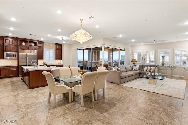 dining room with ceiling fan and sink