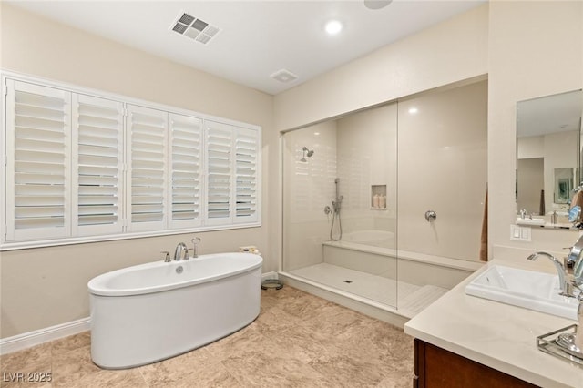 bathroom featuring vanity and independent shower and bath