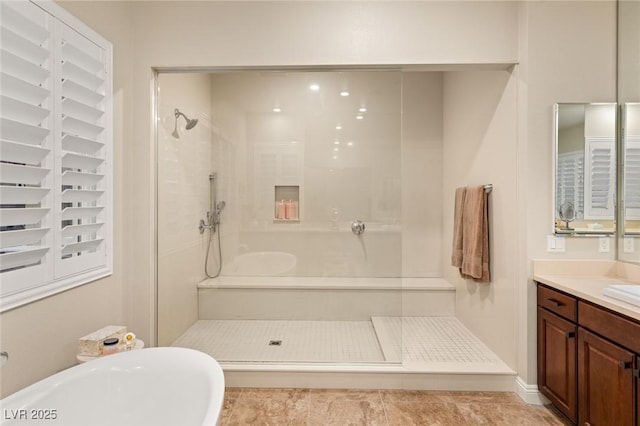 bathroom with tile patterned floors, vanity, and plus walk in shower