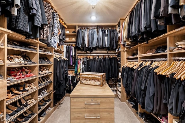 walk in closet featuring light colored carpet