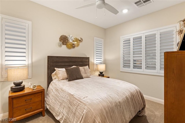 bedroom with ceiling fan and light carpet