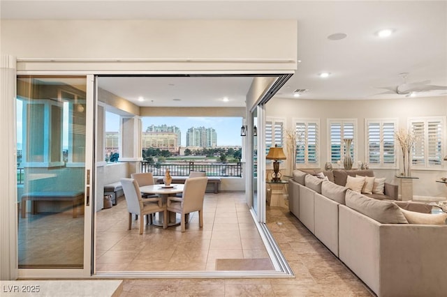 tiled dining space featuring ceiling fan