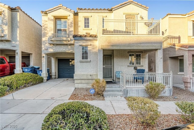 townhome / multi-family property featuring a porch, a garage, and a balcony