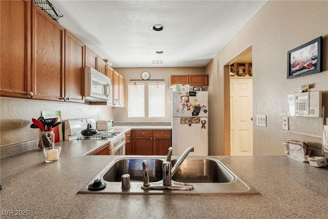 kitchen featuring sink and white appliances