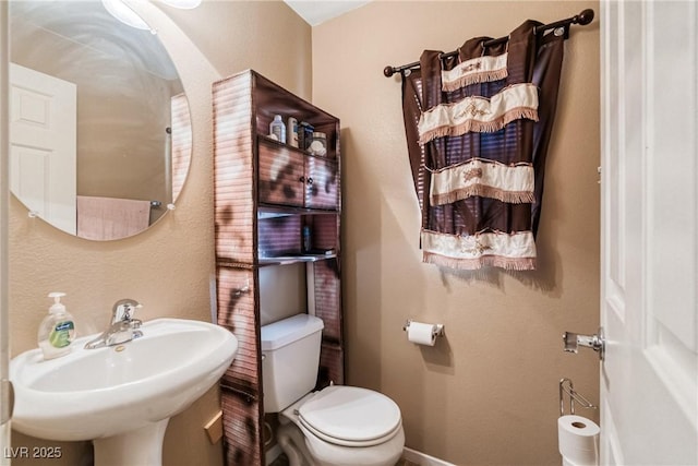 bathroom featuring toilet and sink