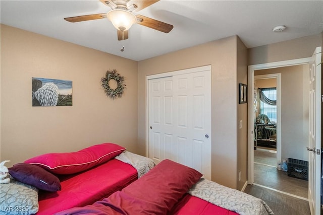 bedroom featuring a closet, ceiling fan, and dark wood-type flooring