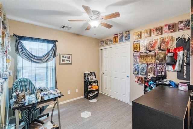 home office featuring hardwood / wood-style flooring and ceiling fan