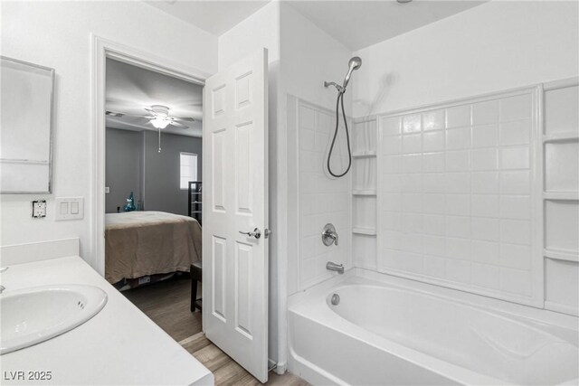 bathroom with vanity, ceiling fan, shower / bathing tub combination, and wood-type flooring