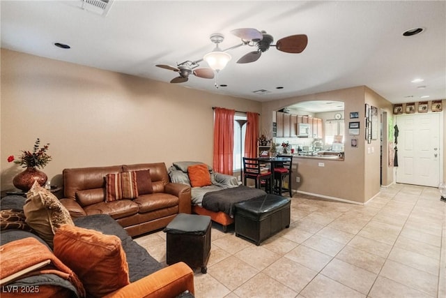 living room with ceiling fan and light tile patterned floors