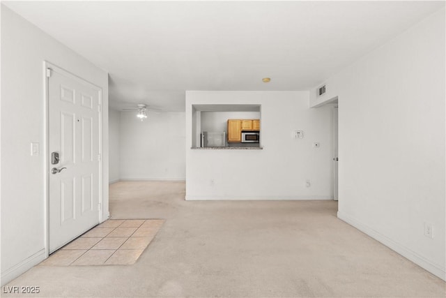 carpeted empty room featuring ceiling fan