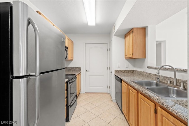 kitchen with light tile patterned floors, sink, and appliances with stainless steel finishes