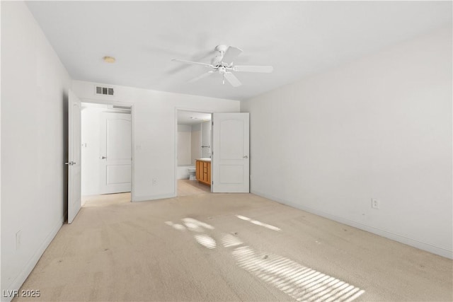 unfurnished bedroom with ensuite bath, ceiling fan, and light carpet