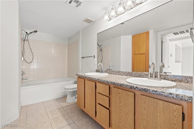 full bathroom with toilet, vanity, tile patterned floors, and tiled shower / bath