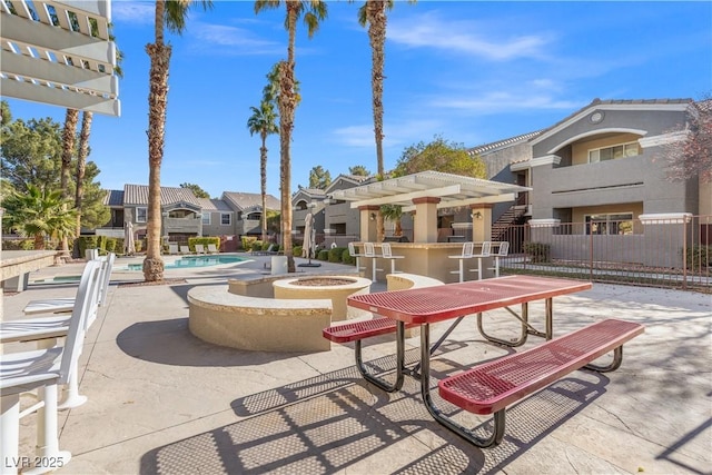 view of community with a pergola, a patio, an outdoor fire pit, and a swimming pool