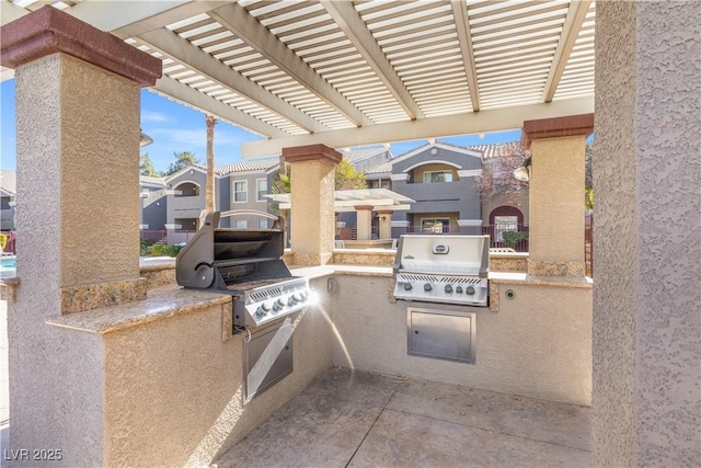 view of patio / terrace with an outdoor kitchen, area for grilling, and a pergola