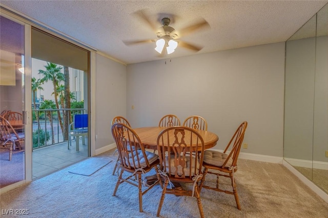 dining space with light carpet, ceiling fan, and a textured ceiling