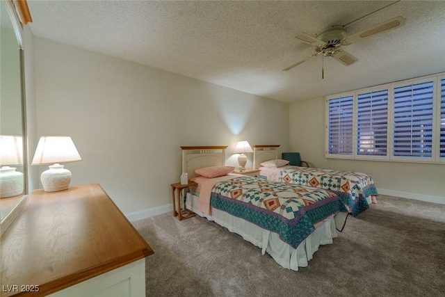 bedroom with carpet flooring, ceiling fan, and a textured ceiling