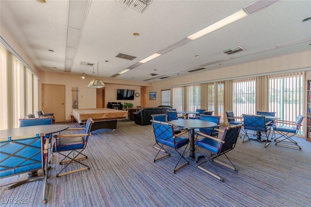 dining area featuring carpet floors, a textured ceiling, and billiards