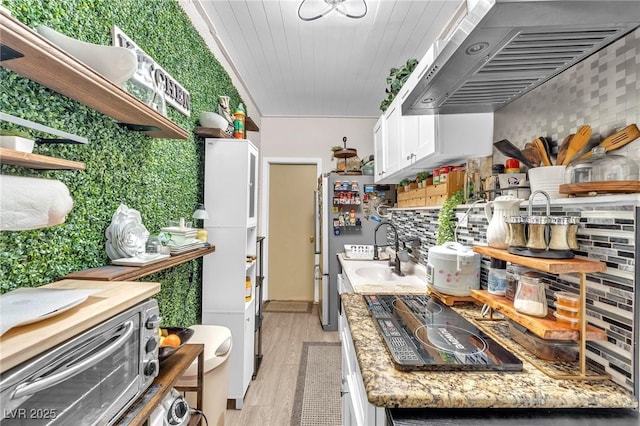 kitchen with open shelves, light wood-style flooring, extractor fan, white cabinets, and black electric cooktop