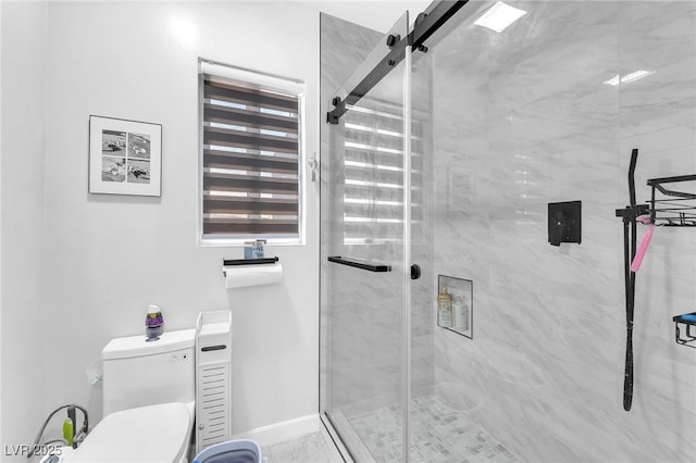 bathroom featuring a shower stall and toilet