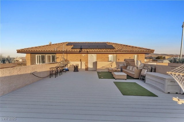 wooden deck with outdoor dining area and an outdoor hangout area