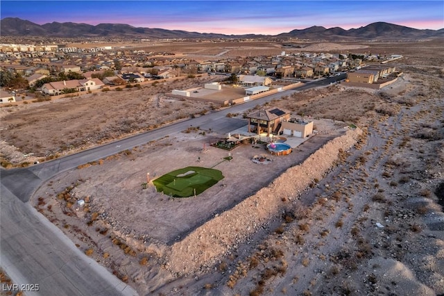 aerial view at dusk with a residential view and a mountain view