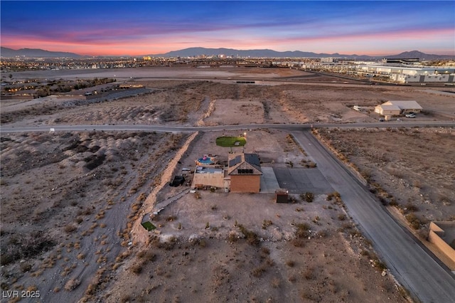 aerial view at dusk featuring a mountain view