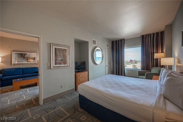 bedroom with dark colored carpet