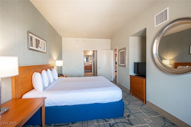 bedroom with dark colored carpet