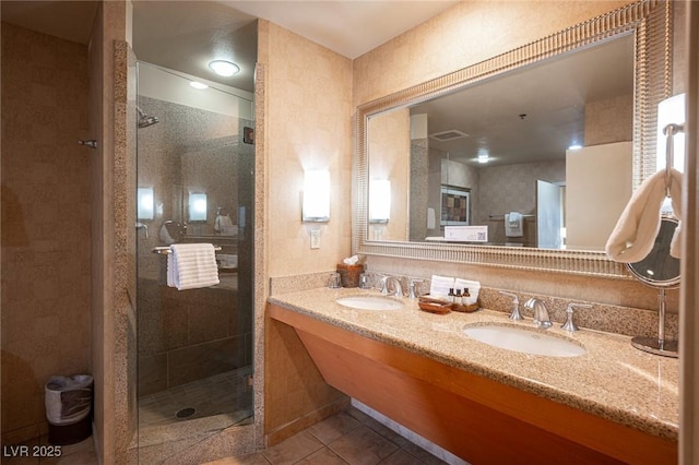 bathroom featuring tile patterned flooring, vanity, and walk in shower