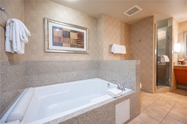 bathroom with tile patterned floors, separate shower and tub, and tile walls