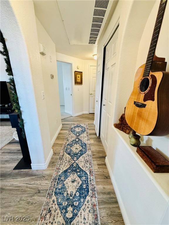 hallway with wood-type flooring