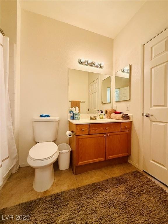 bathroom with tile patterned floors, a shower with curtain, vanity, and toilet