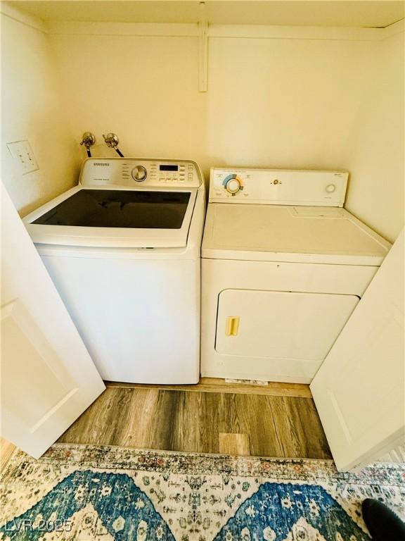 washroom featuring washer and dryer and hardwood / wood-style flooring