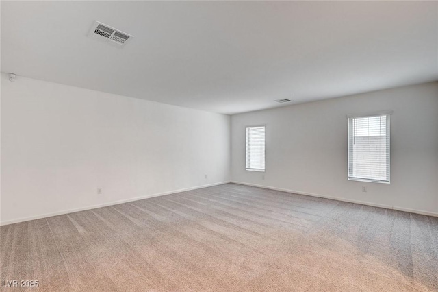 carpeted empty room with plenty of natural light