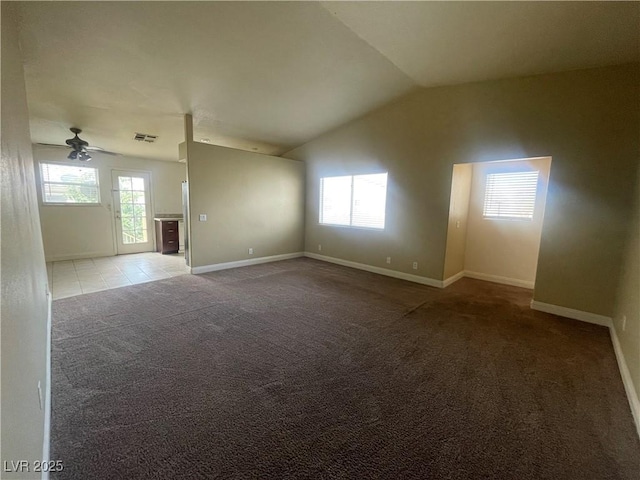 empty room with ceiling fan, carpet floors, and vaulted ceiling