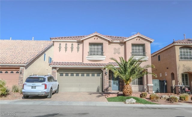 mediterranean / spanish-style house with a garage