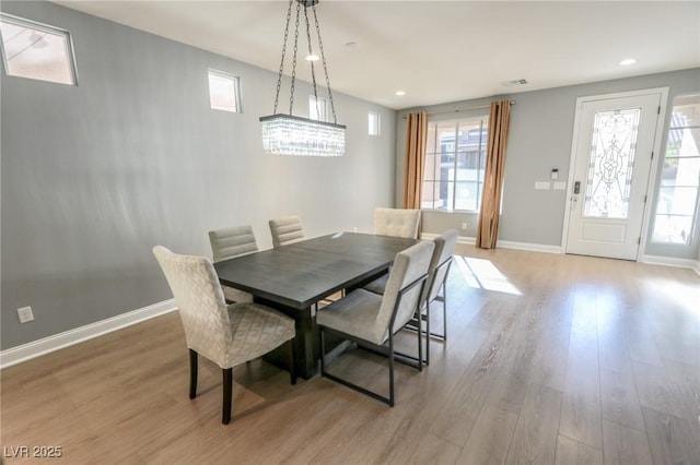 dining area featuring a chandelier and light hardwood / wood-style flooring