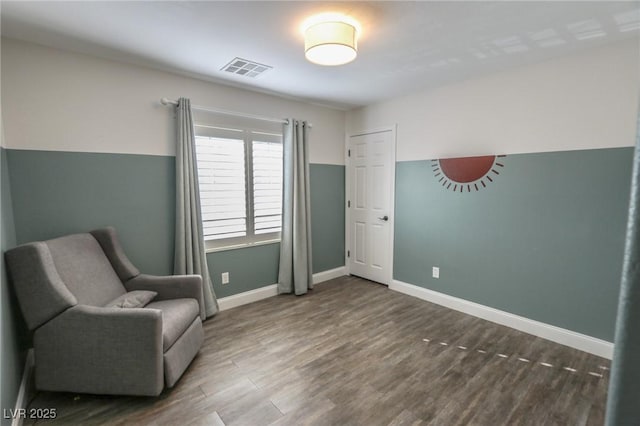 sitting room with dark wood-type flooring